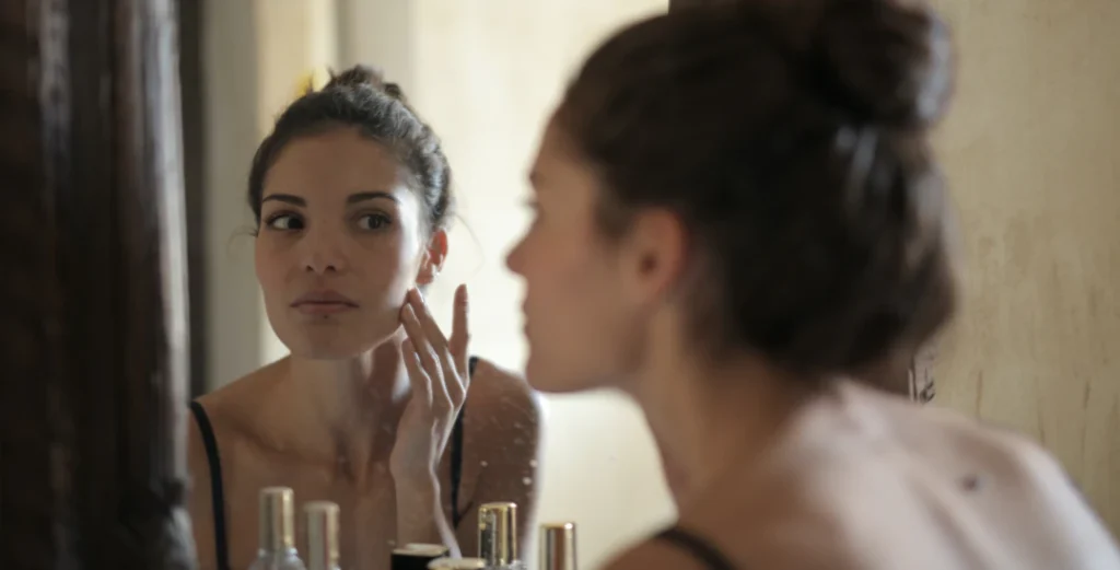 woman checking for pimples